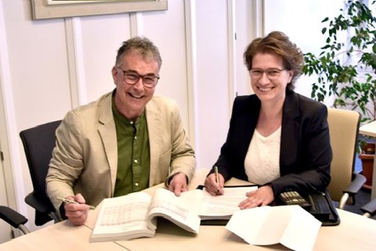 Bürgermeister Heide und Frau Itgenshorst die an einem Tisch siutzen